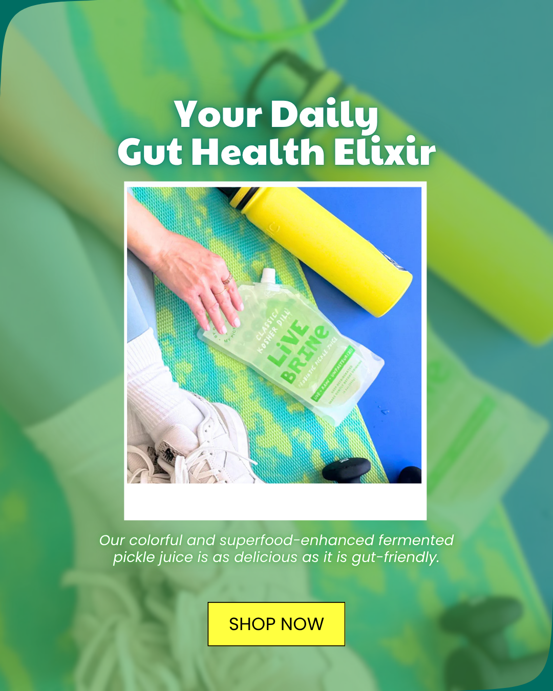 A person's hand holds a Live Brine pickle juice pouch on a green yoga mat next to a yellow water bottle and athletic shoes.