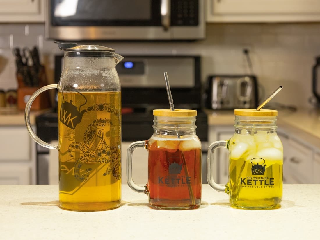 Decisive Iced Tea Brewer next to 2 frosty mason jars filled with black and green iced teas
