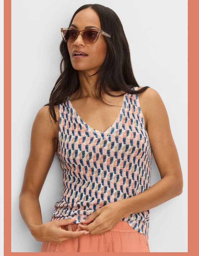 The lady wearing the Sideways Sweater Tank.