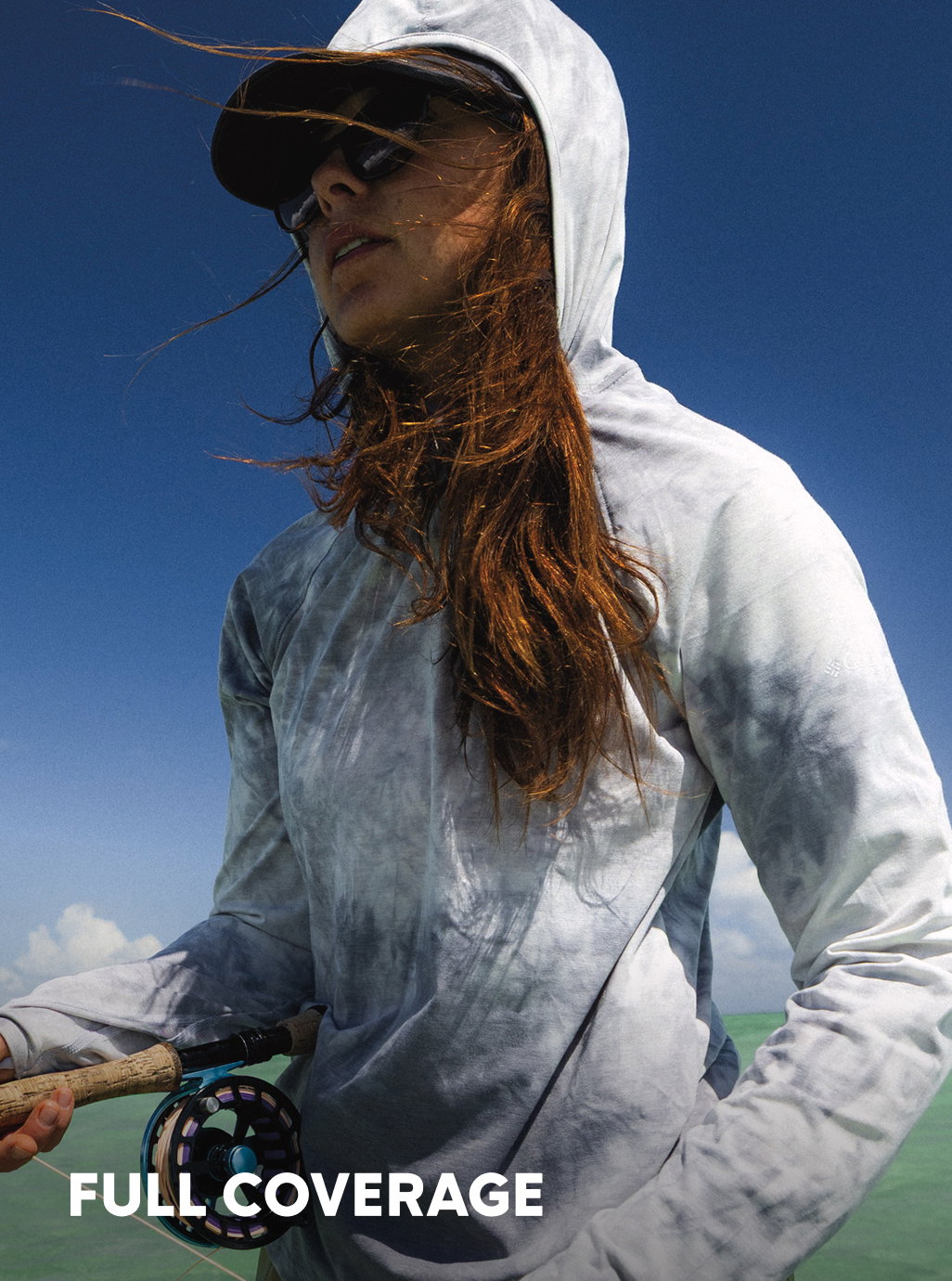 Headline: Full Coverage. A woman focused on fishing. 