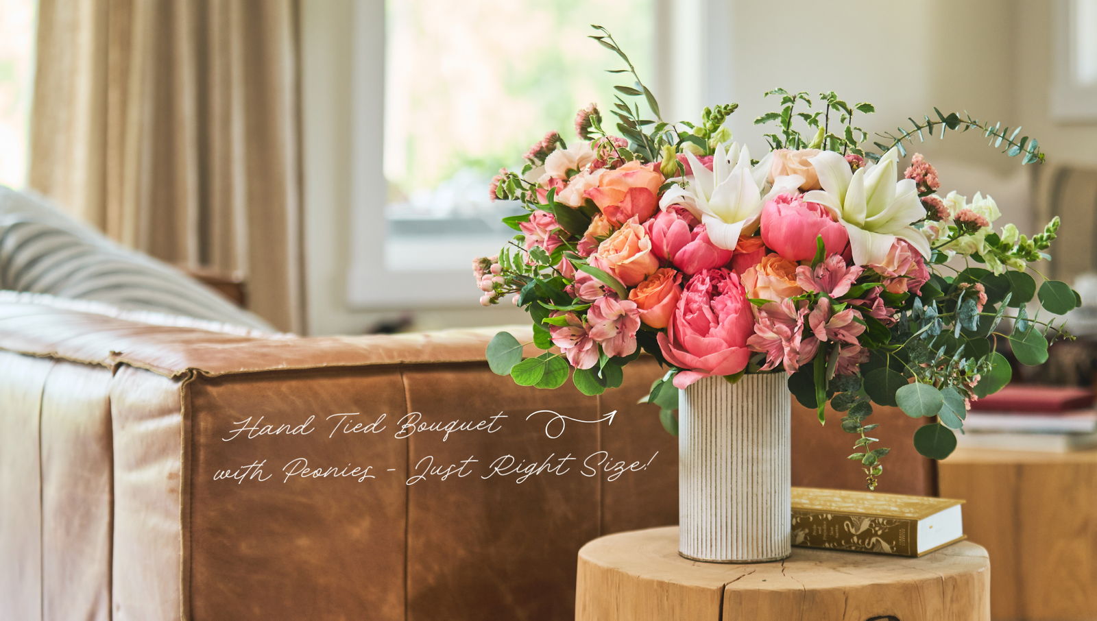 Product feature for “Fancy That,” showing a pink, blush, green, and white floral arrangement in a cream vase held out by someone in a blue sleeve. Text on the right reads “Fancy That” with a “Shop Now” link.