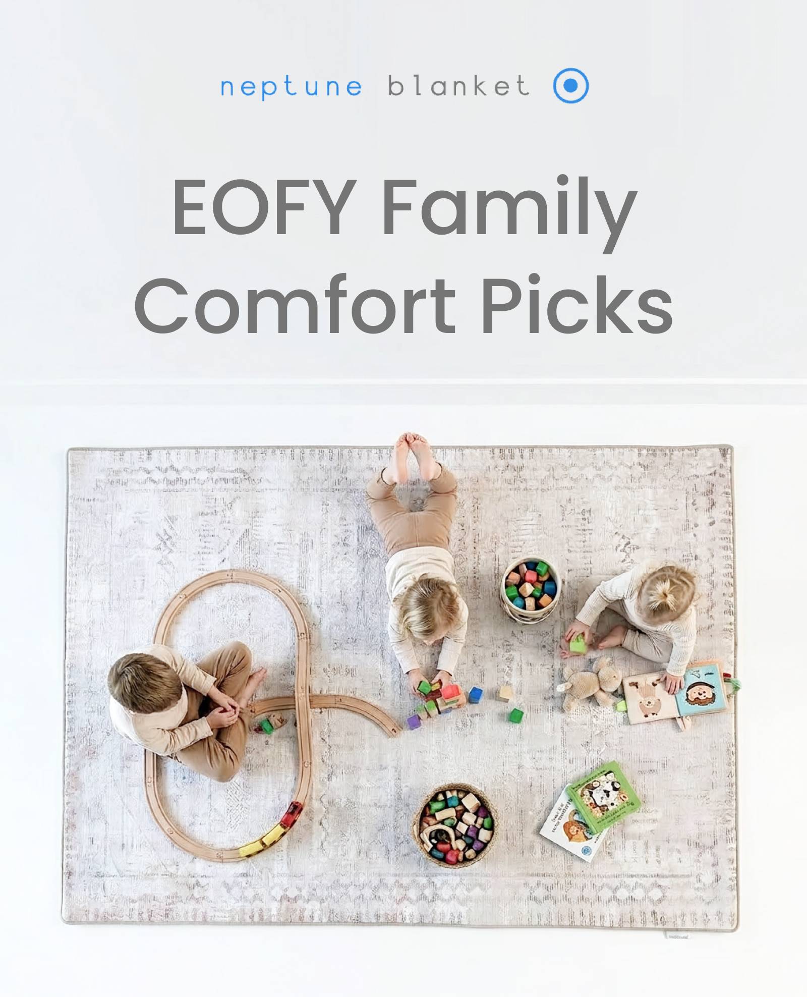 An overhead medium shot shows three children playing on a light-colored rug with a grey patterned design, featuring the text 'neptune blanket' and 'EO...