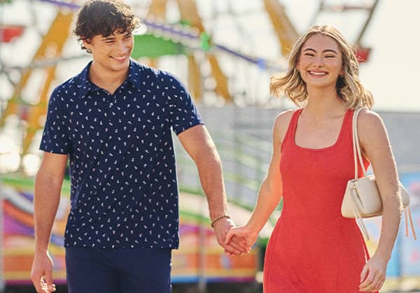 Image of Jockey model in a polo holding hands with a model in a dress