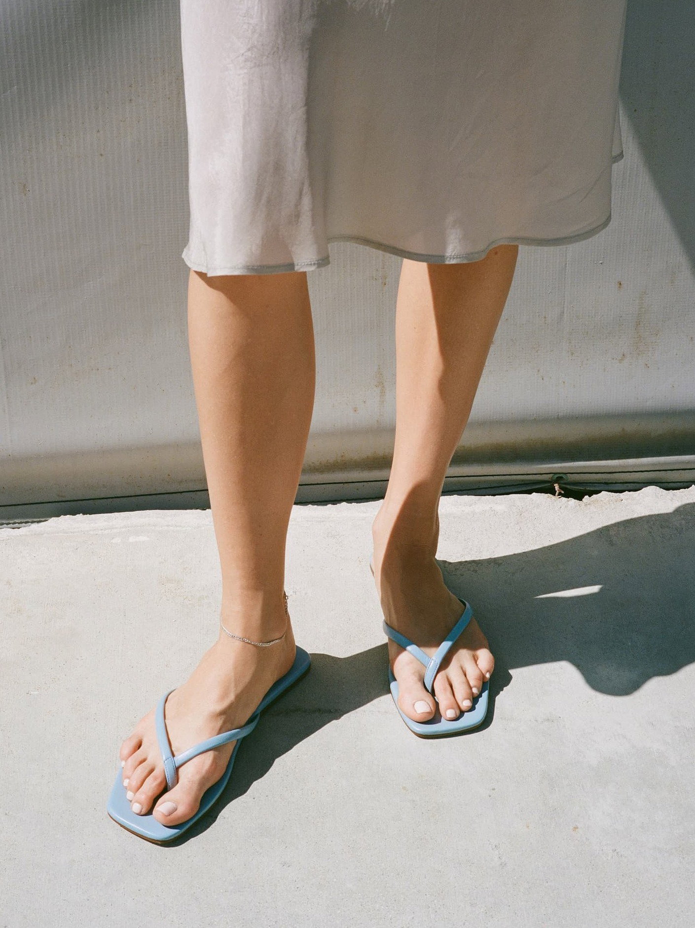 Person wearing blu flip flops