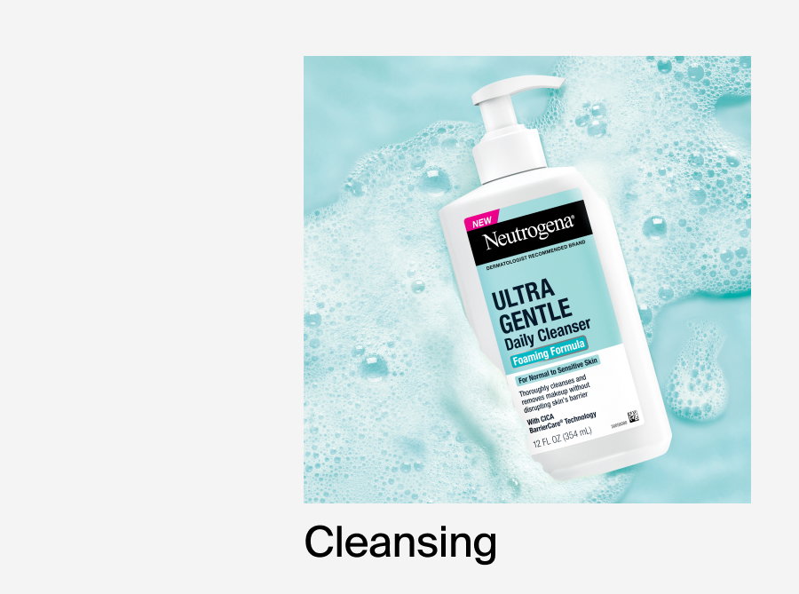 Neutrogena® Ultra Gentle Daily Cleanser Foaming Formula lying on sudsy light blue background