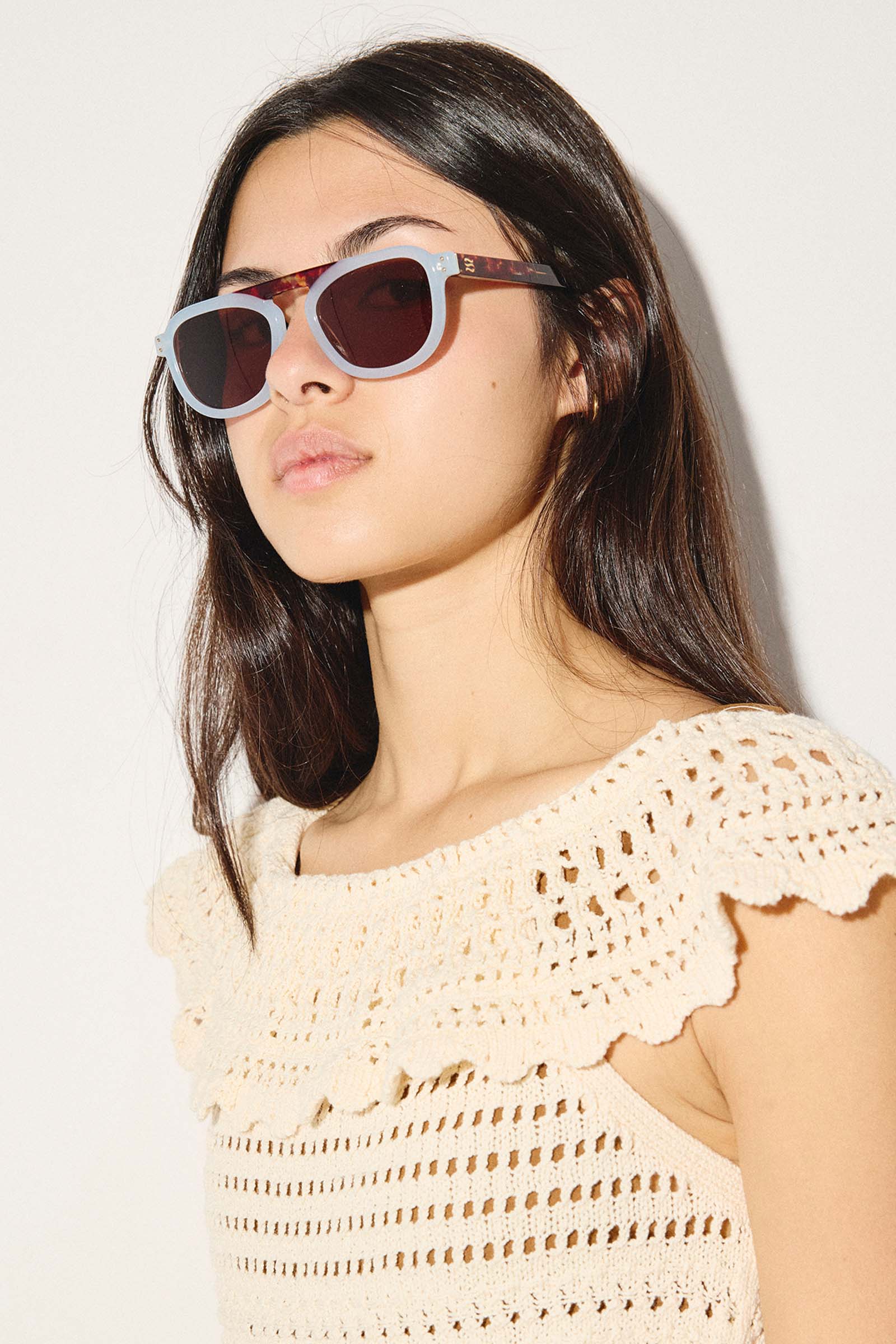woman wearing blue sunglasses in crochet dress
