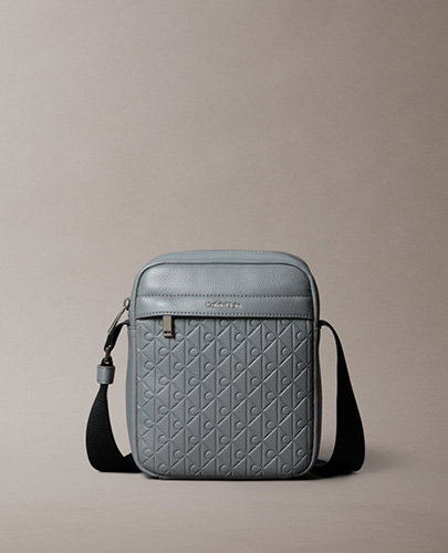 EMBOSSED ALLOVER MONOGRAM REPORTER BAG