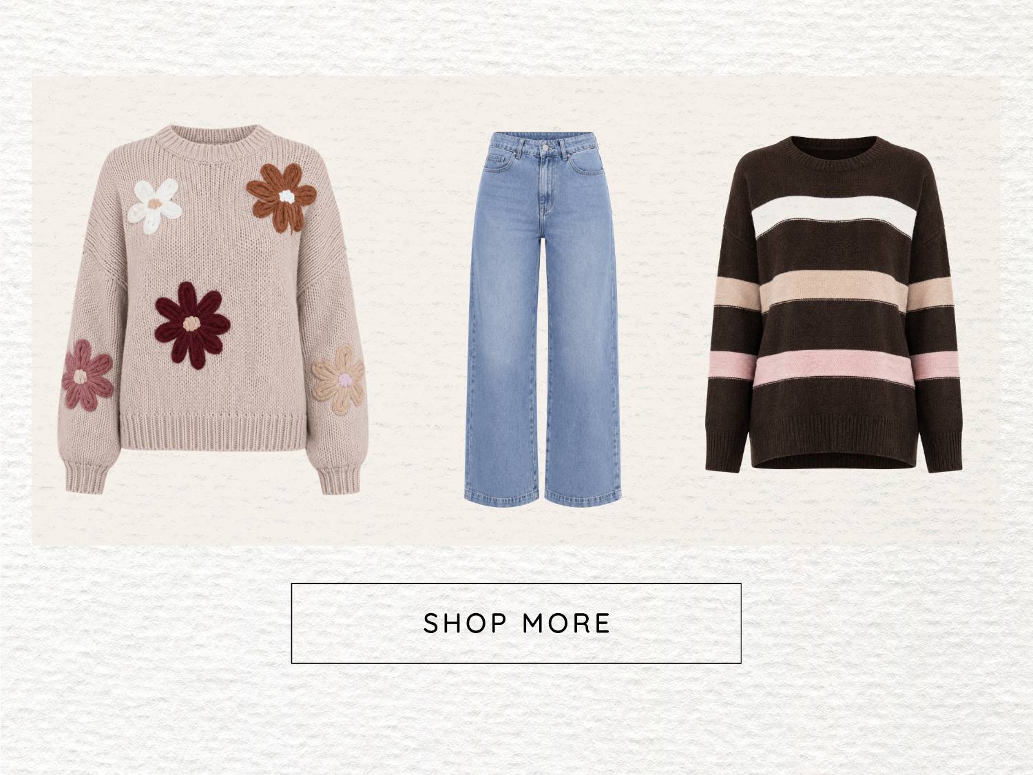 A flat-lay composition displays a beige knit sweater with floral appliques, light wash wide-leg jeans, and a dark brown striped sweater with white, be...