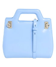Light blue structured handbag with top handle, gold hardware and strap detail, shown front-on against a plain background. 