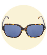 Oversized tortoiseshell square-frame sunglasses with blue tinted lenses, shown front-on against a soft circular background.				