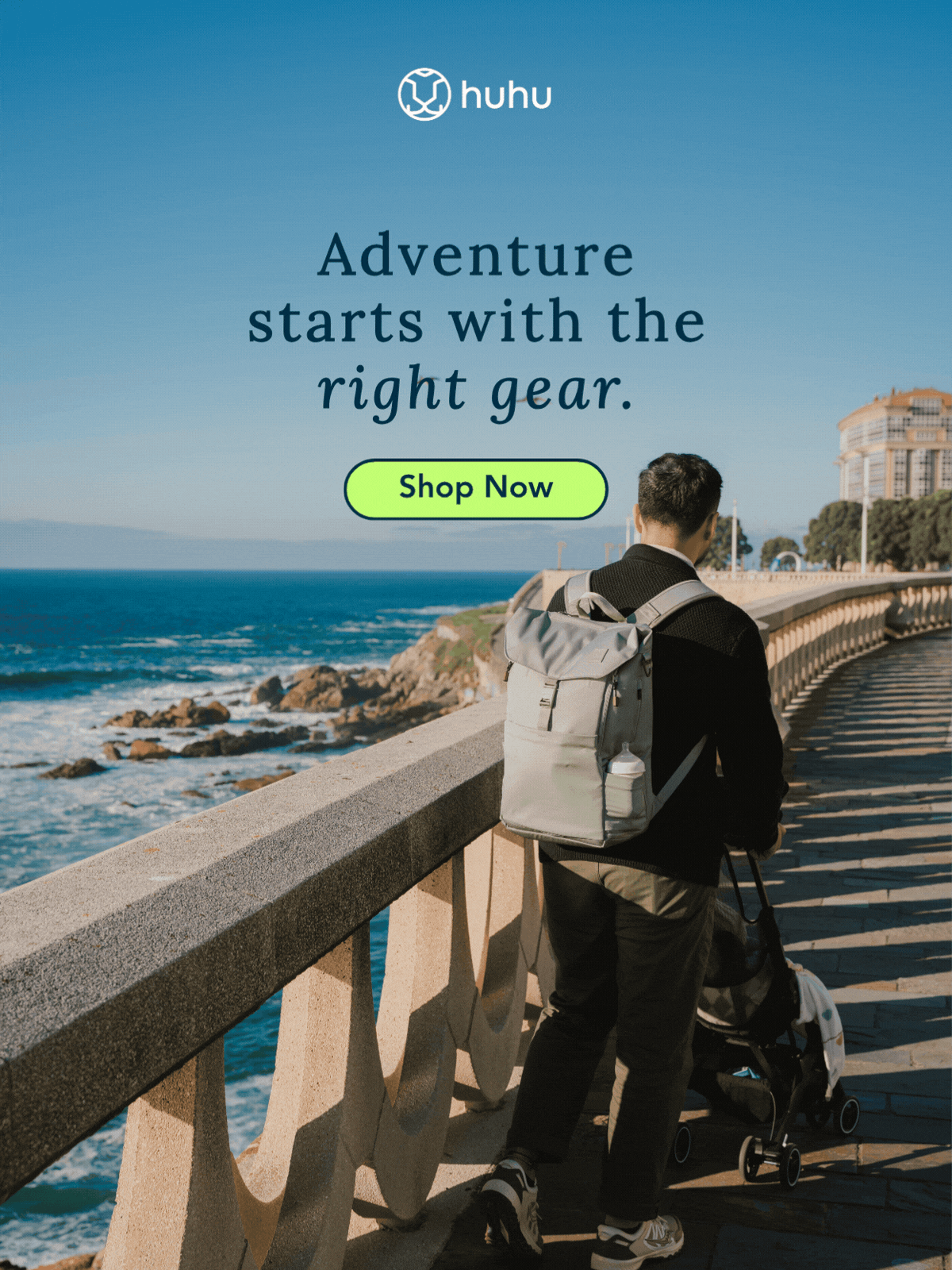 photo of dad wearing backpack pushing stroller along the beach