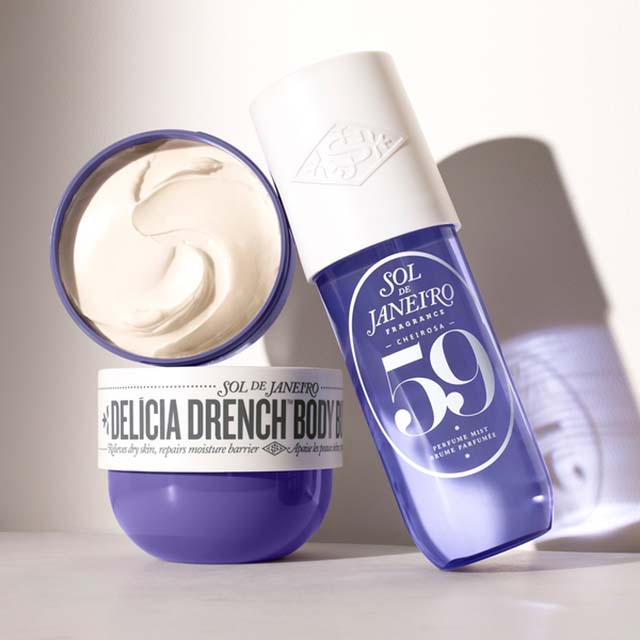 Sol de Janeiro Delicia Drench body cream and a spray bottle of scent, both in purple containers with white accents.
