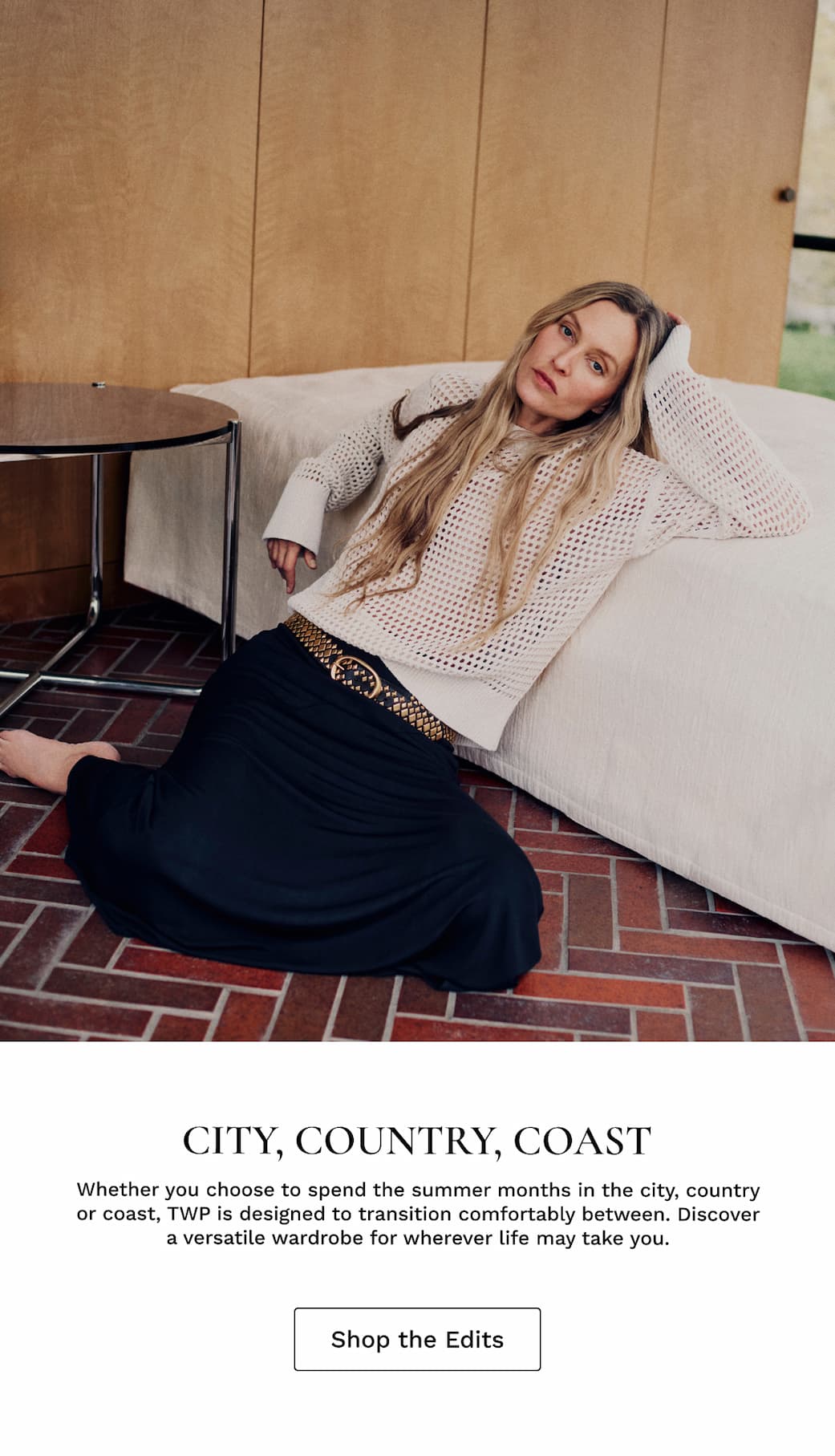 Image of a model sitting on the floor with black text beneath.