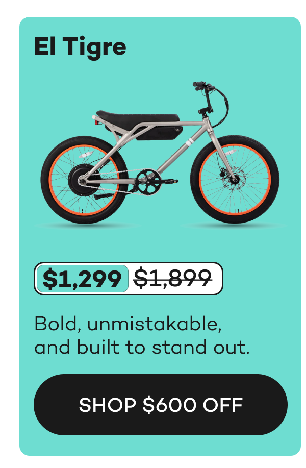 El Tigre bike in silver with orange accents, priced at $1,299, originally $1,899.
