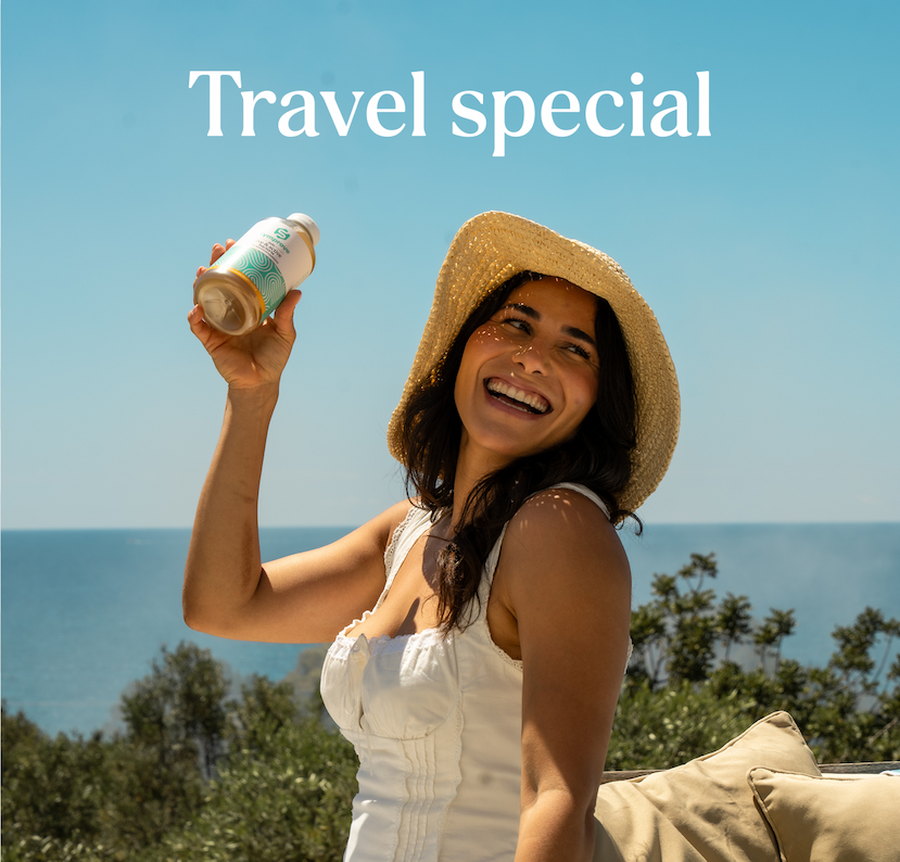 Travel Special | Lady holding a bottle of Symprove in the sunshine