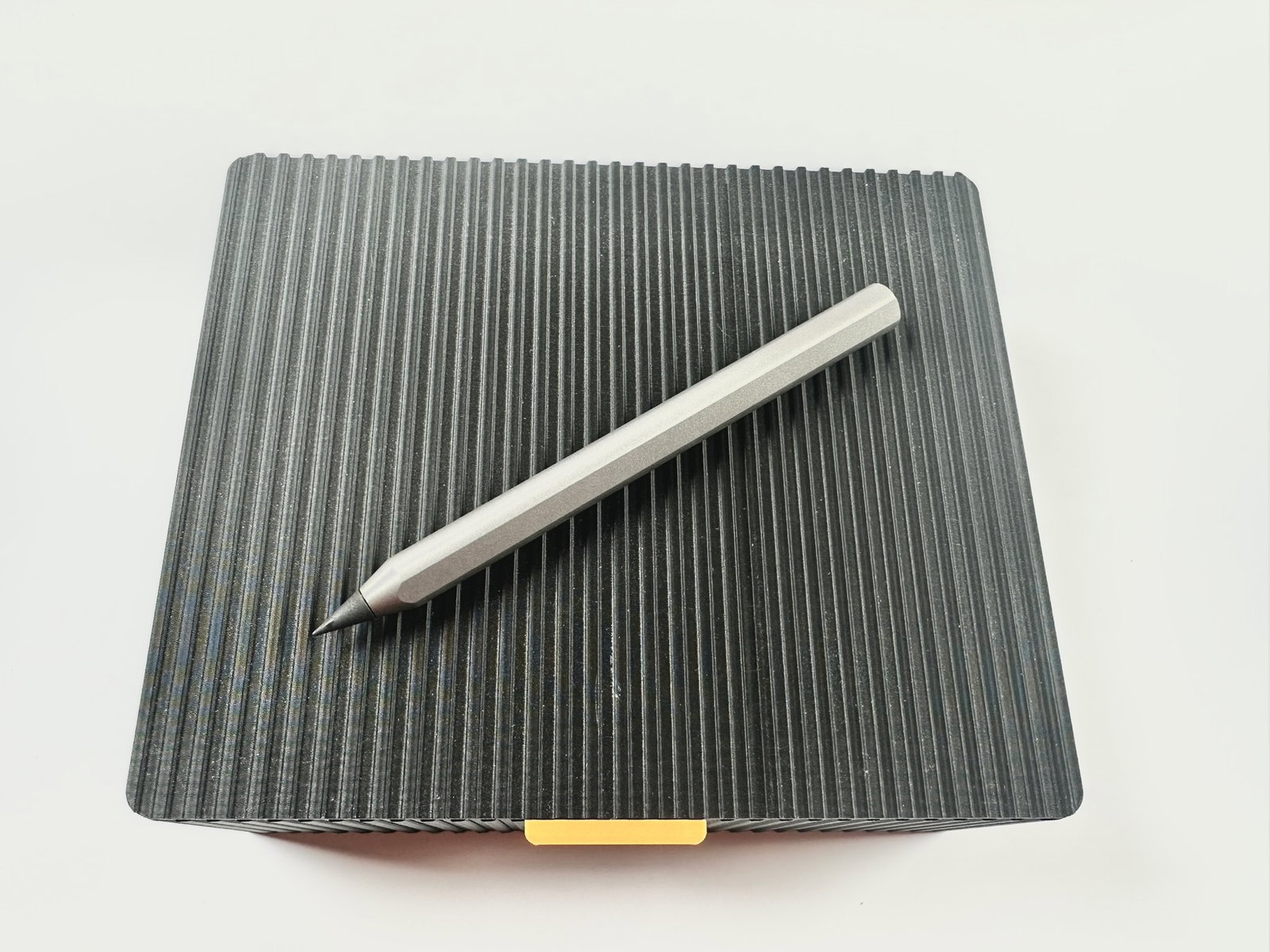 The Infinity Pencil on a ribbed notebook