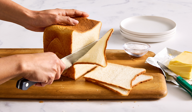Serrated knife slicing bread