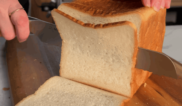 Serrated knife slicing bread