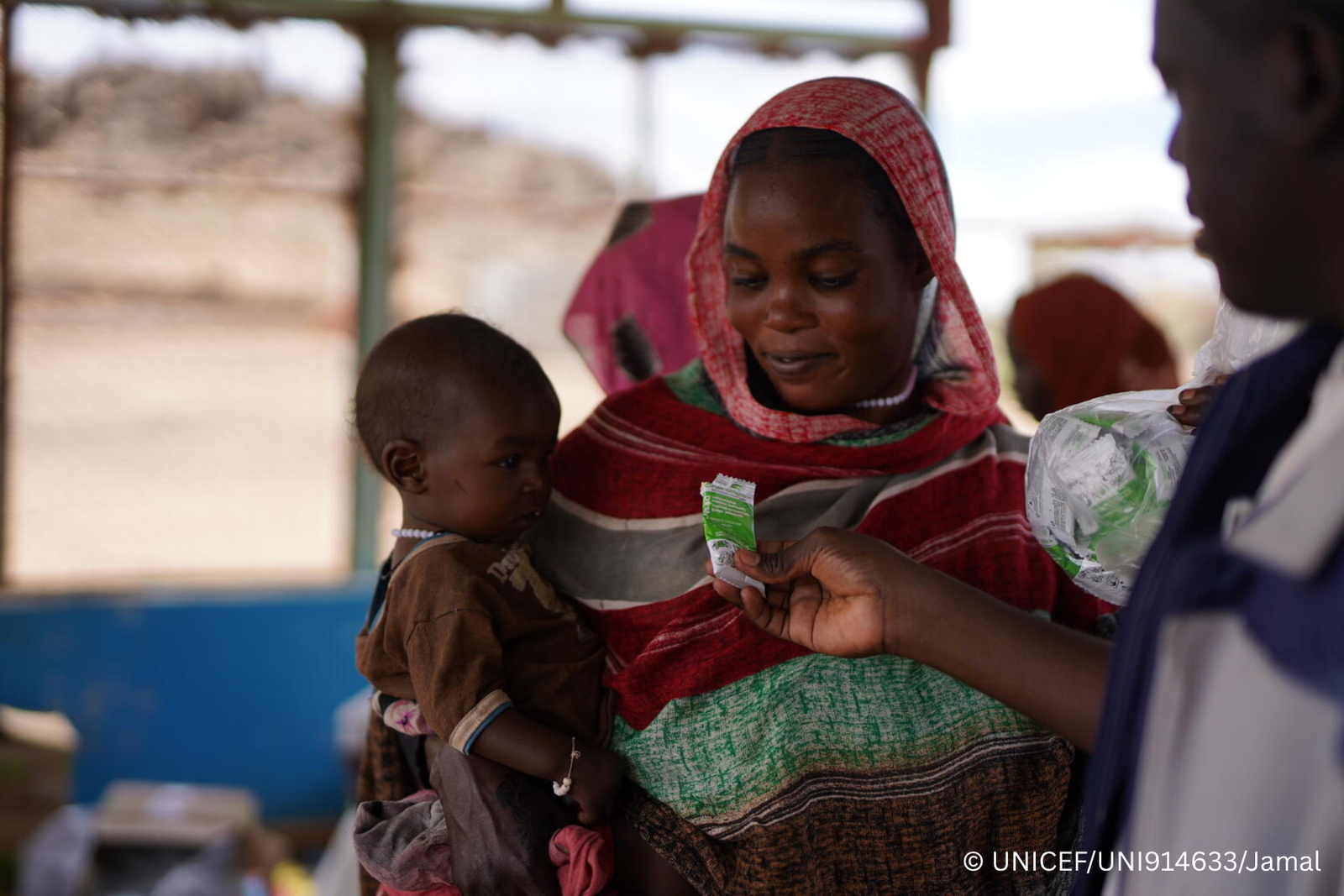 Halimah's seven-month-old daughter, Asyaa, who suffers from malnutrition, is given a sachet of ready-to-eat therapeutic food (RUTF) during a follow up visit to a UNICEF-supported nutrition centre in Sudan.