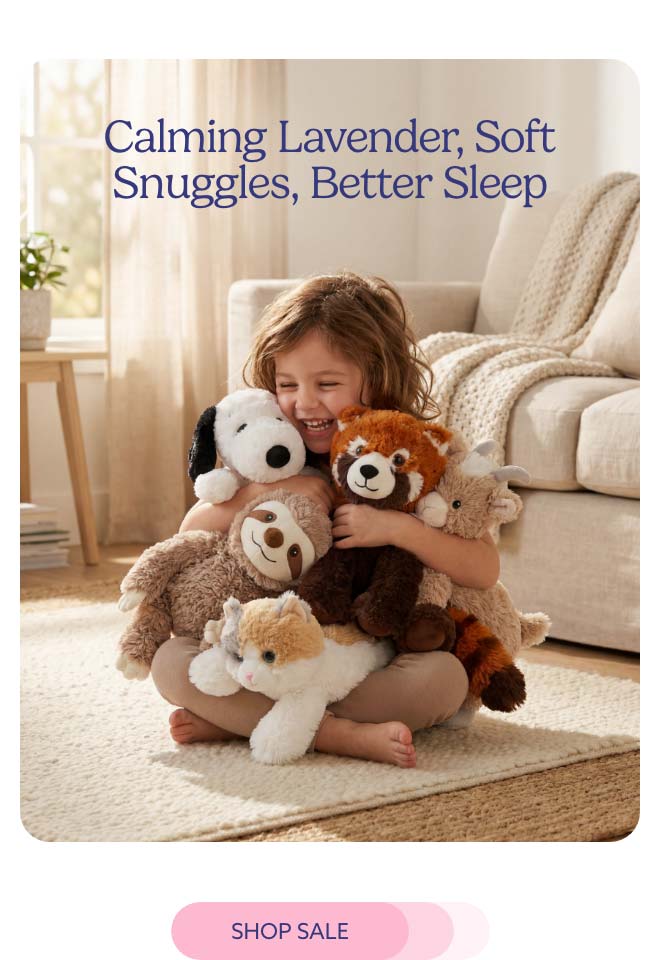 A child hugging a pile of Warmies. Shop Sale.