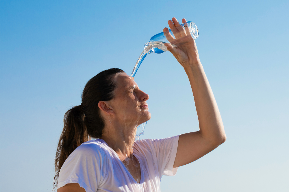 woman pouring water on herself