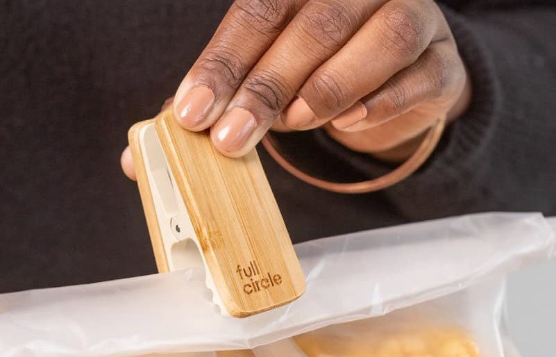 Person is affixing a bamboo bag clip to a bag of cereal