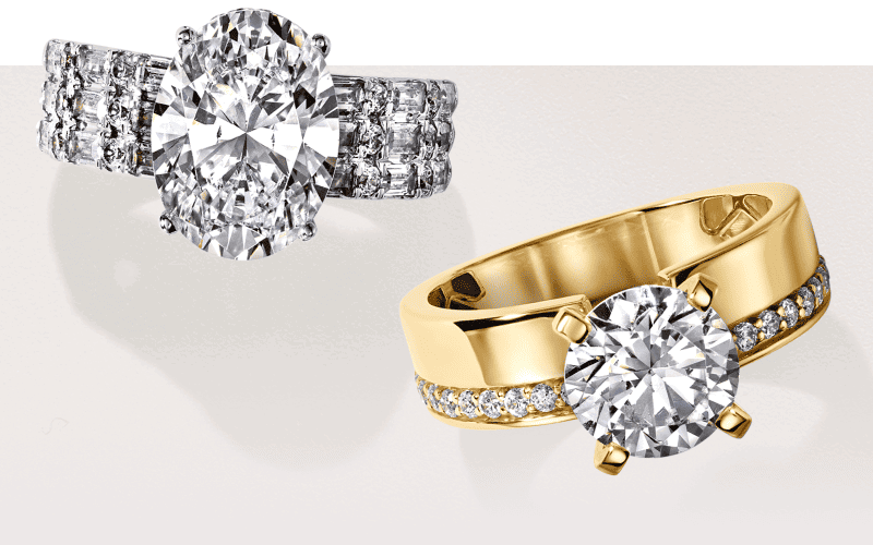 White gold engagement ring with an oval diamond and diamond-accented band beside a yellow gold round solitaire diamond ring.