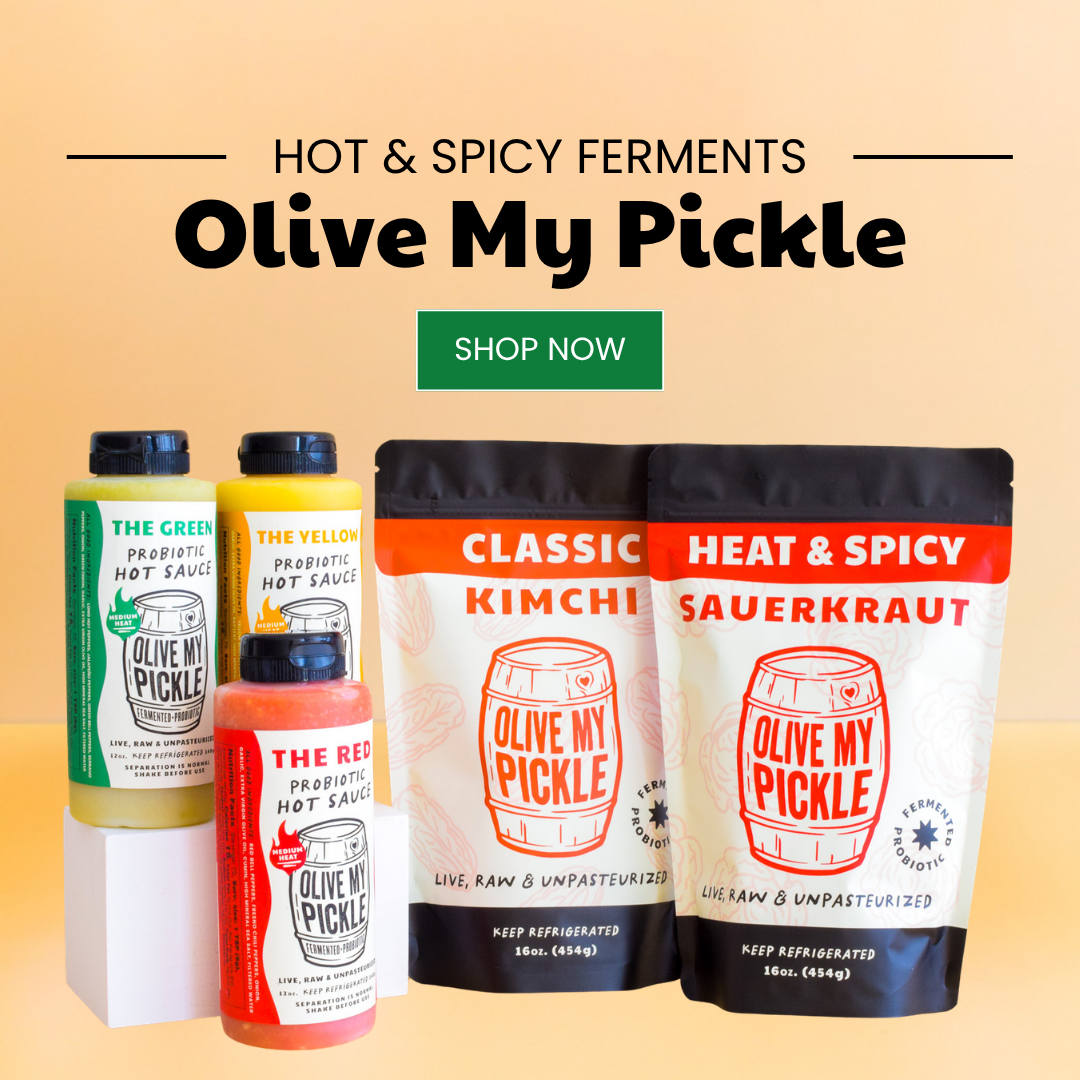 Product display of Olive My Pickle hot sauces (green, yellow, red) and pouches of Classic Kimchi and Heat & Spicy Sauerkraut on a white surface with an orange b