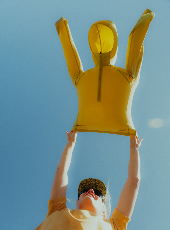Holding a Sunshield™ Hoody in the air