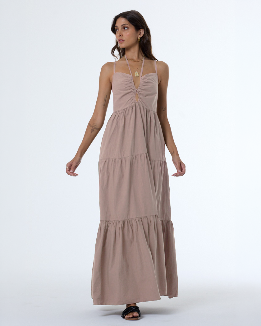 Woman wearing tan loose fit cotton dress