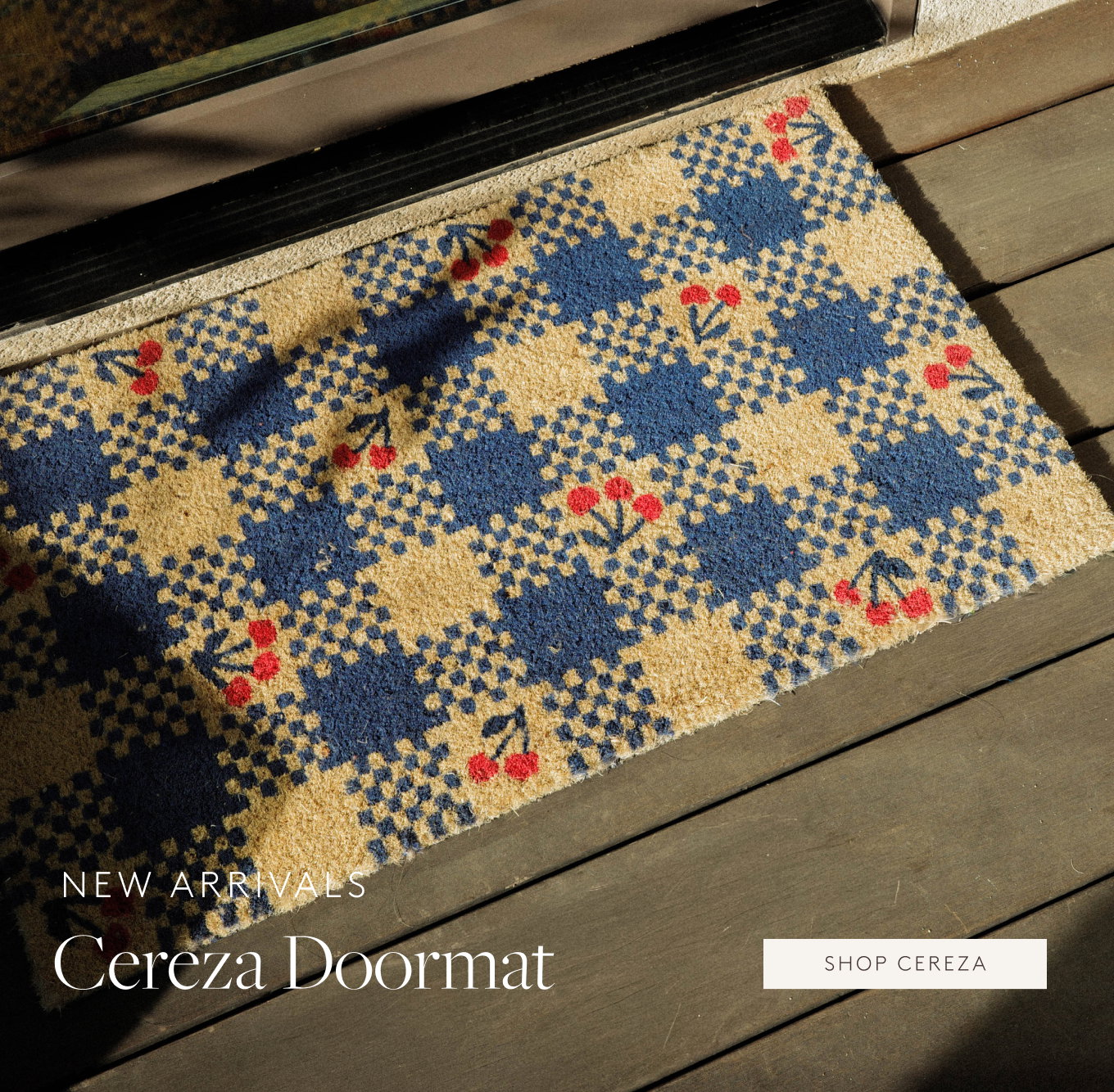 Blue and yellow checked doormat with a cherry pattern