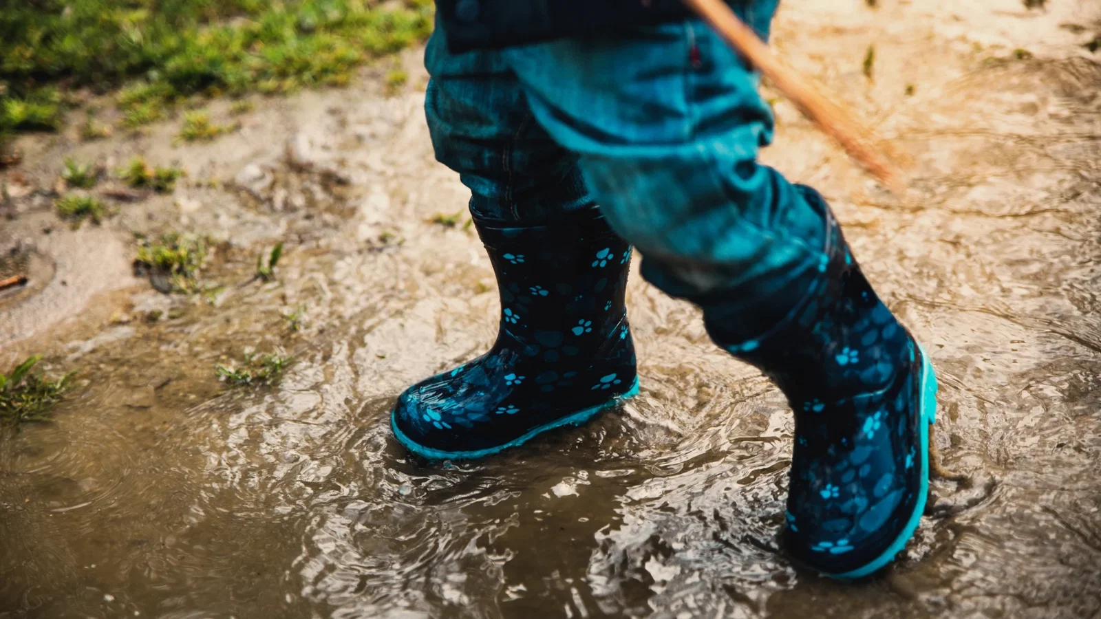 wellies splashing through water on mud mission