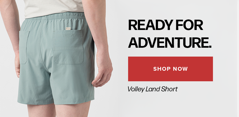 Rear view of a person wearing light blue-green shorts against a white background. Text reads: 'Ready For Adventure. Shop Now Volley Land Short'