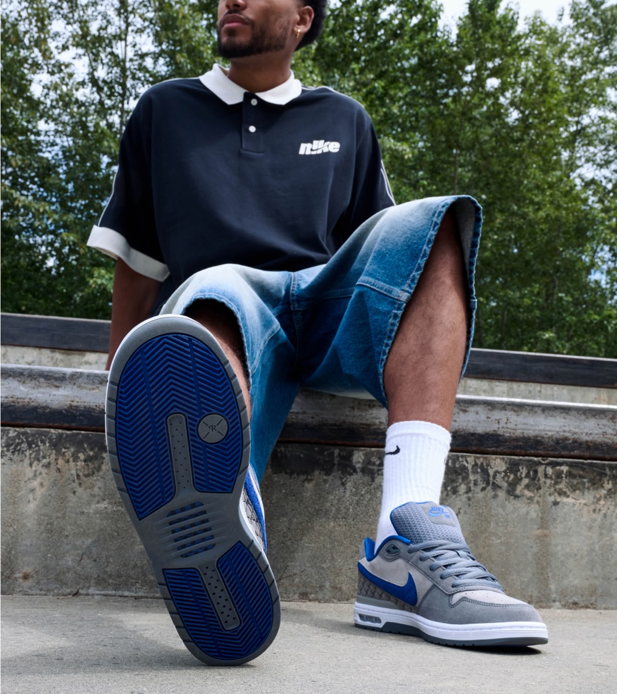 Shop the new Nike P-Rod 1's dropping in Dodgers Blue | A man showcasing the sole of the shoe, which is also Dodgers Blue