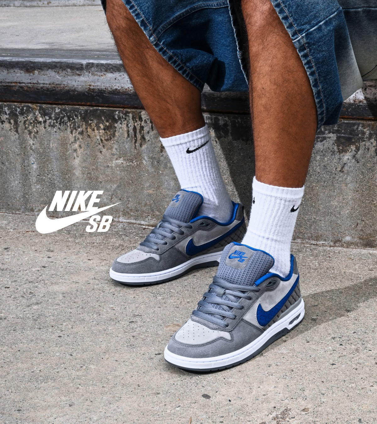 Shop the new Nike P-Rod 1's dropping in Dodgers Blue | A man sitting sideways, showcasing the blue Nike swoop logo.
