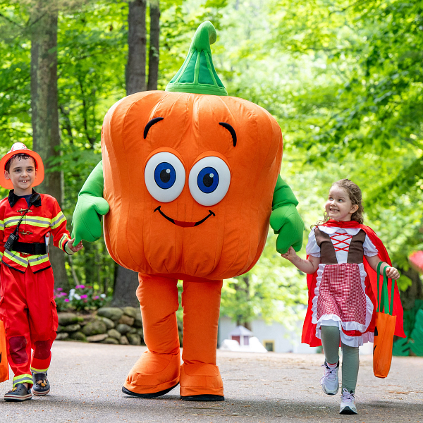 Spookley the Square Pumpkin with two kids holding hands