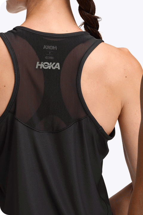 Moodboard showing two images: one image shows a man from the chin to the waist wearing a black vest with the HOKA symbol on the chest; the other image shows a woman viewed from behind, from the neck to the waist, wearing a black vest with the HOKA logo centered.