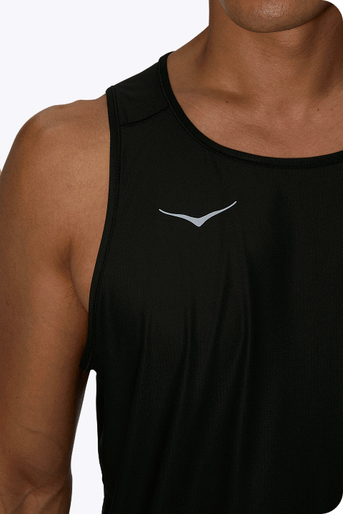 Moodboard showing two images: one image shows a man from the chin to the waist wearing a black vest with the HOKA symbol on the chest; the other image shows a woman viewed from behind, from the neck to the waist, wearing a black vest with the HOKA logo centered.