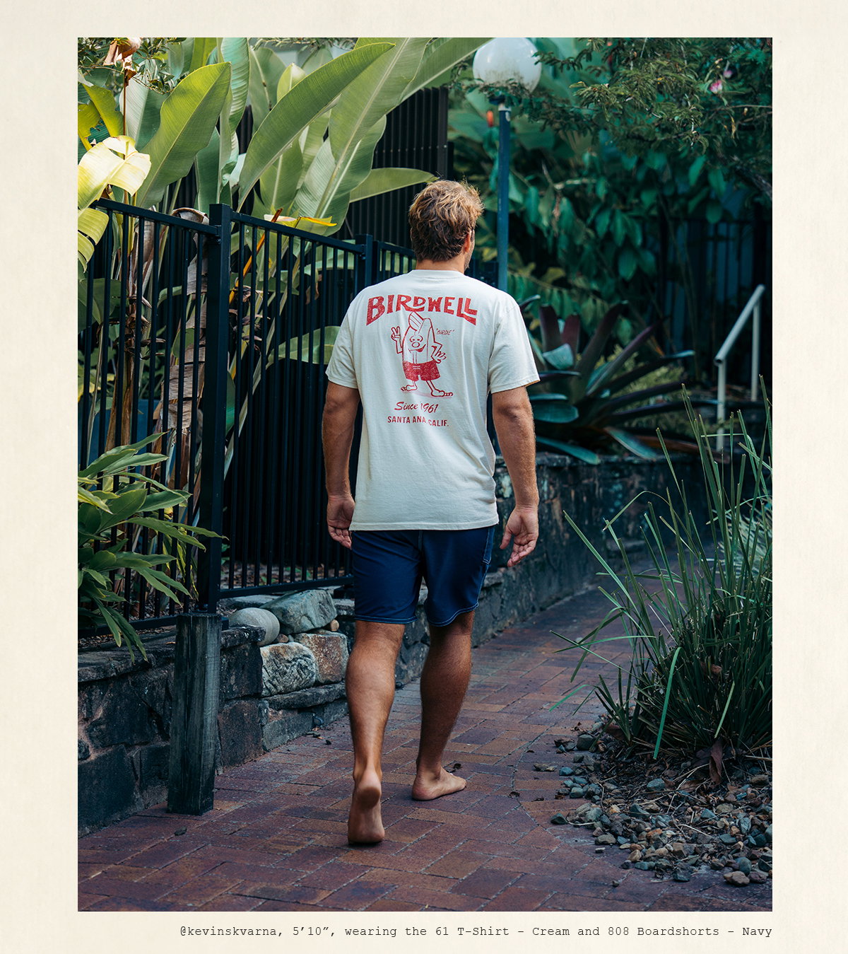 Kevin, 5'10", wearing the 61 T-Shirt - Cream and 808 Boardshorts - Navy