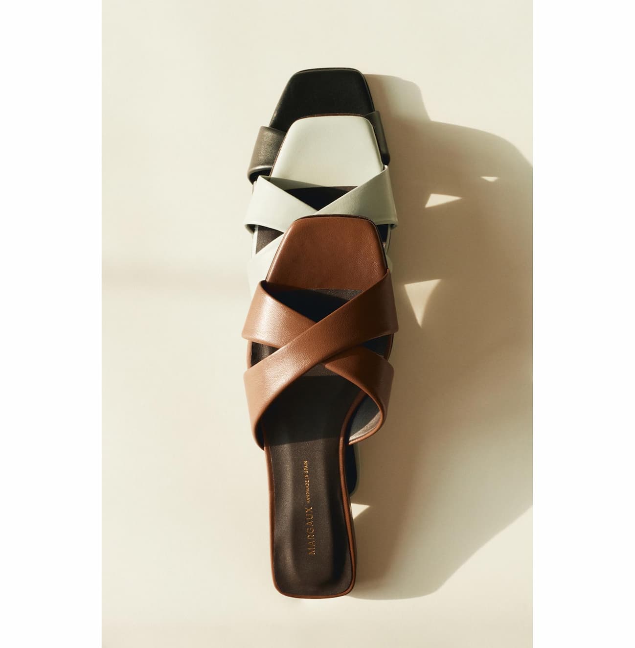 The Selene Flat Sandal in Cognac, Sky and Black