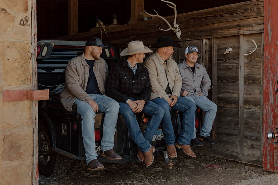 A group of men wearing Justin Boots.