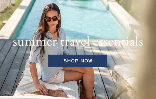 Summer Travel Essentials - Shop now - Image of a woman wearing a blue tee