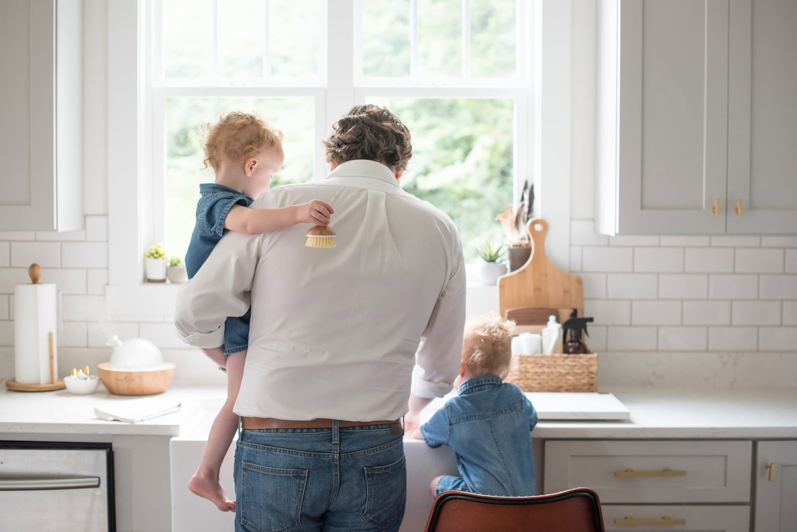 Dad at the sink with two children