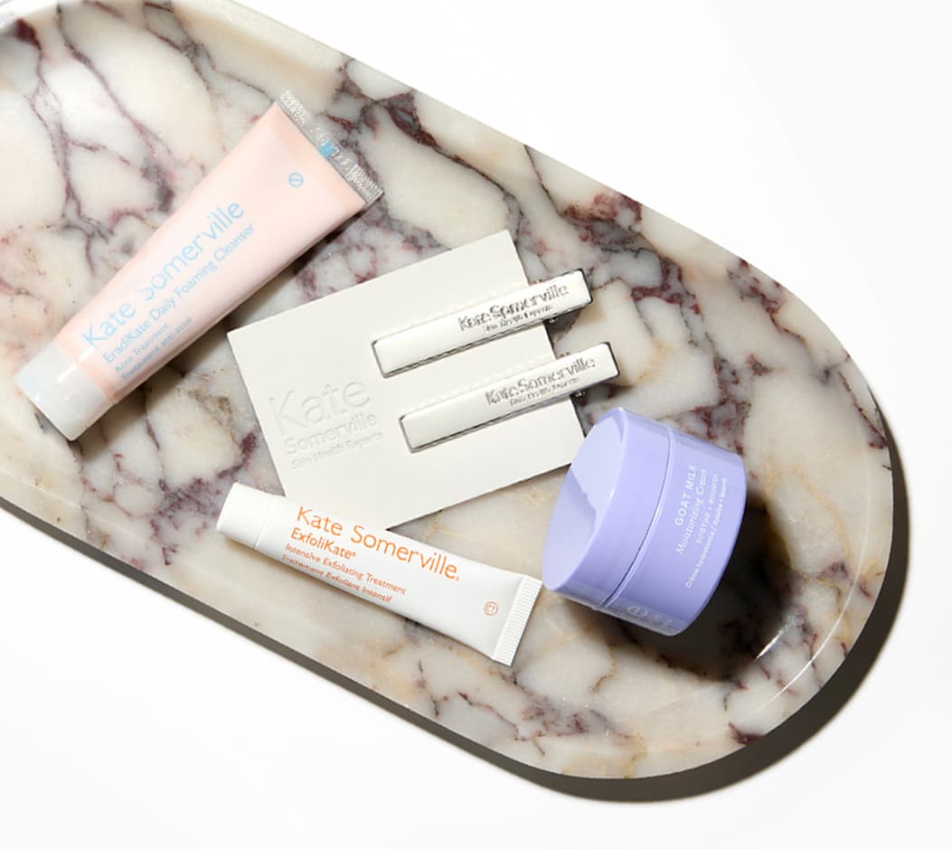 Marble Tray of EradiKate Cleanser, ExfoliKate Intensive + Goat Milk Cream minis, and Silver Barrette Set.