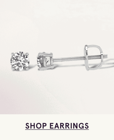 Pair of round-cut diamond studs set in four-prong white metal setting. Click here to shop earrings