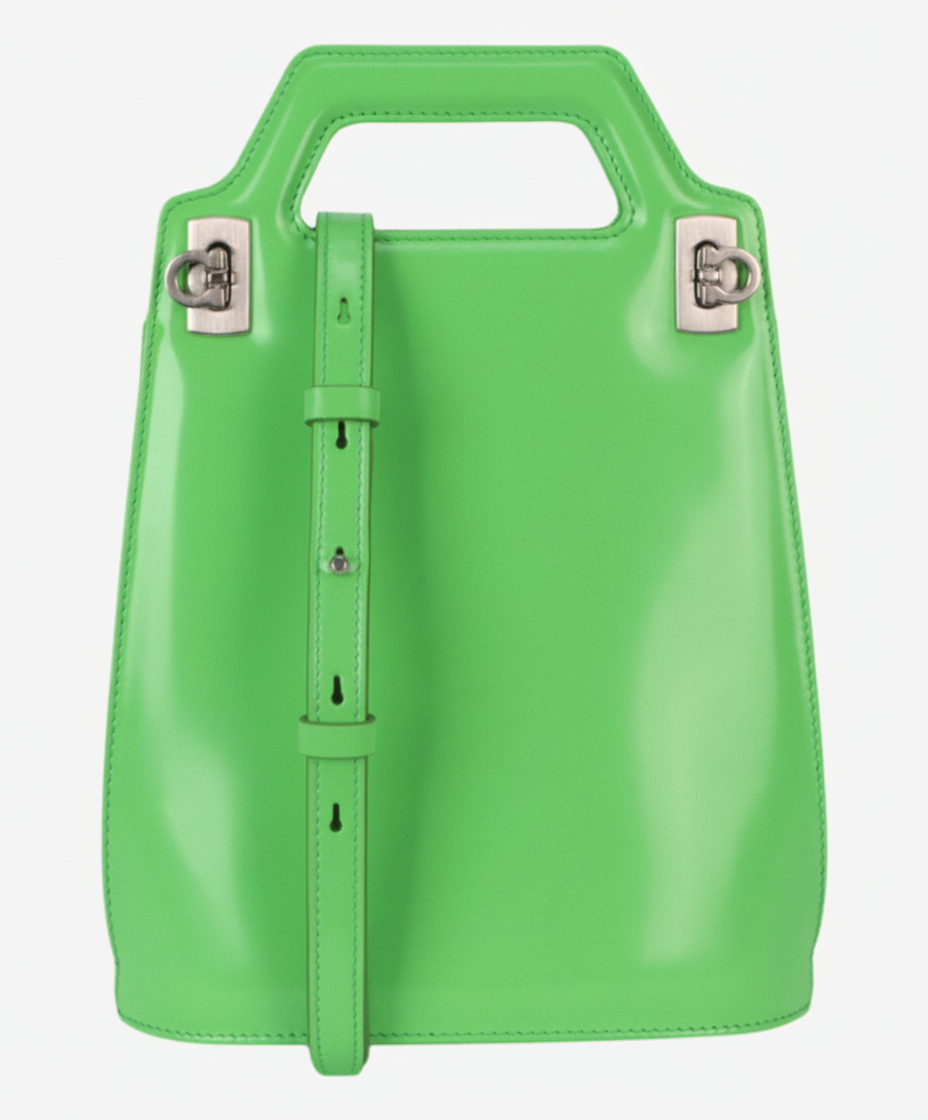 A bright green leather handbag with a top handle and a detachable shoulder strap.