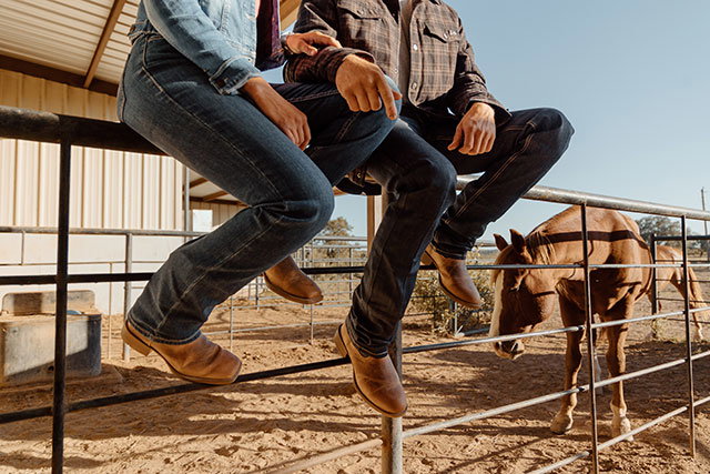 A man and a woman wearing Justin Boots.