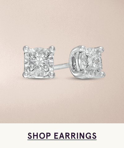 Pair of princess-cut diamond studs set in traditional four-prong white metal setting. Click here to shop earrings