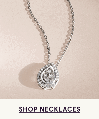 Chain necklace with teardrop pendant cluster closely set with diamonds. Click here to shop necklaces