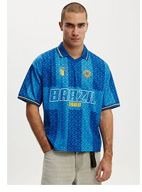 Man wearing blue patterned short sleeve shirt with text graphic